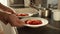 Closeup of woman serving dinner and taking two bowls with hot soup. Domestic food, cooking at home, housewife working.