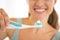 Closeup on woman showing electric toothbrush