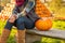 Closeup on woman sitting with pumpkin