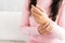 Closeup woman sitting on sofa holds her wrist hand injury