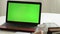 Closeup woman sitting table notebook female hands keyboarding laptop using texting pointing networking green screen