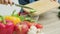 Closeup of woman slices cucumber for diet salad.