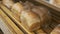 Closeup of Woman Taking Lots of Loafs of Bread