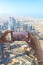 Closeup of woman tourist hand taking photo of Dubai city with smartphone camera from Burj Khalifa tower.