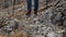 Closeup of Woman Traveler Crossing Rocky Terrain