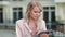 Closeup woman using tablet computer at street. Businesswoman working on touchpad