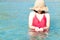 Closeup woman wearing red bikini playing sea water with happy feeling, Holiday and relax concept