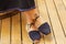 Closeup womans feet wearing simple traditional andean shoes, lace with knot tied around lower leg, legs crossed