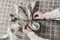 Closeup of womans hands folding napkins. Easter decorative table setting. Spring still life with quail and hen eggs