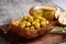 Closeup wood bowl of pimento olives with bread and oil