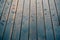 Closeup of wood planks while raining in perspective. Background of wooden natural surface and raindrops