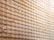 Closeup wooden blind textures with yellow sunlight in cafeteria.