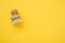 Closeup of wooden dishwashing brush on a yellow surface - space for text