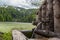 Closeup of a wooden drinking water fountain next to a lake during daylight