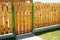 Closeup on wooden gate ( wicket ) and wooden fence detail construction with doorway outdoor.