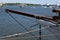 A closeup of a wooden jib boom of an old sailboat moored at the pier