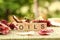 Closeup of wooden letter cubes spelling the word OILS on a wooden fence under the sunlight