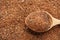 Closeup of wooden spoon with ground mixed pepper