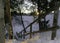 Closeup of wooden stairs of a hiking trail covered by snow on background of the shining sun