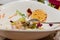 Closeup of wooden table with messy half eaten green vegetable salad