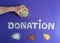 Closeup of word donation on purple background