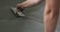 Closeup worker applying micro concrete on the floor with a trowel