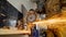 Closeup of worker using a grinder cuts metal in a workshop