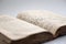 Closeup of worn shabby jewish holy book. Open page of Torah. Selective focus