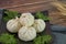 Closeup of xiaolongbao Chinese steamed bun on black plate, wood background