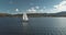 Closeup yacht racing at port town on ocean coast aerial. Sailboat regatta under sails at open sea