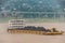 Closeup of yellow barge with coal sailing on Yangtze River, China