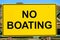 Closeup of a yellow no boating sign
