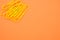 Closeup of yellow paperclips on orange background with space for your text
