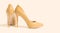 Closeup yellow women patent leather shoe isolated light background. Stilettos shoe type. Summer fashion and shopping concept.