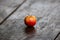 Closeup of a yellowish-red apple on the wooden surface.