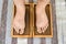 Closeup of yoga person standing on sadhu board with sharp nails