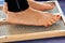 Closeup of yoga person standing on sadhu board with sharp nails