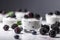 Closeup Of Yogurt With Fresh Blackberries On White Background, Minimalist Style. Generative AI