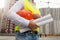 Closeup of young architect posing with hardhat and blueprints on