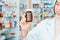 Closeup young asian pharmacist pill bottle mockup at qualified pharmacy