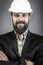 Closeup of young engineer with hardhat holding arms folded