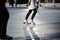 Closeup of young girl on the fugure skates outdoor in sunny spring day