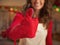 Closeup on young housewife in kitchen gloves showing thumbs up