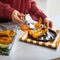 Closeup on young housewife serving baked pumpkin