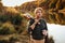 Closeup of young man hands hold acoustic bass guitar ukulele at the park Enjoy living Sunshine in the evening.