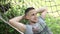 Closeup Young man lying down and swinging in hammock in pleasant laziness of weekend morning in forest. Man Relaxing in hammock i