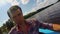 Closeup young man paddling kayak on river, action camera, selfie