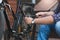 Closeup of young man repairing bicycle rear wheel