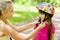 Closeup young mother dresses her daughter\'s bicycle helmet