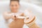 Closeup on young woman in bathtub using body brush